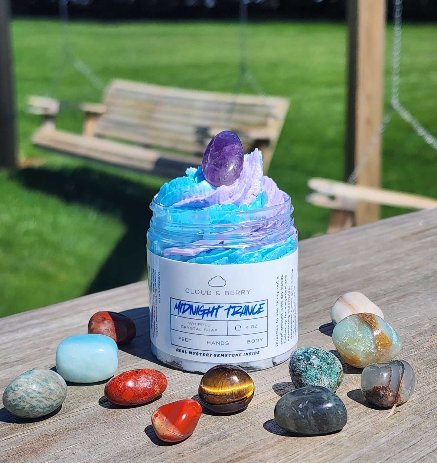midnight trance whipped crystal soap, blue and purple swirls with 12 random gemstones surrounding it.