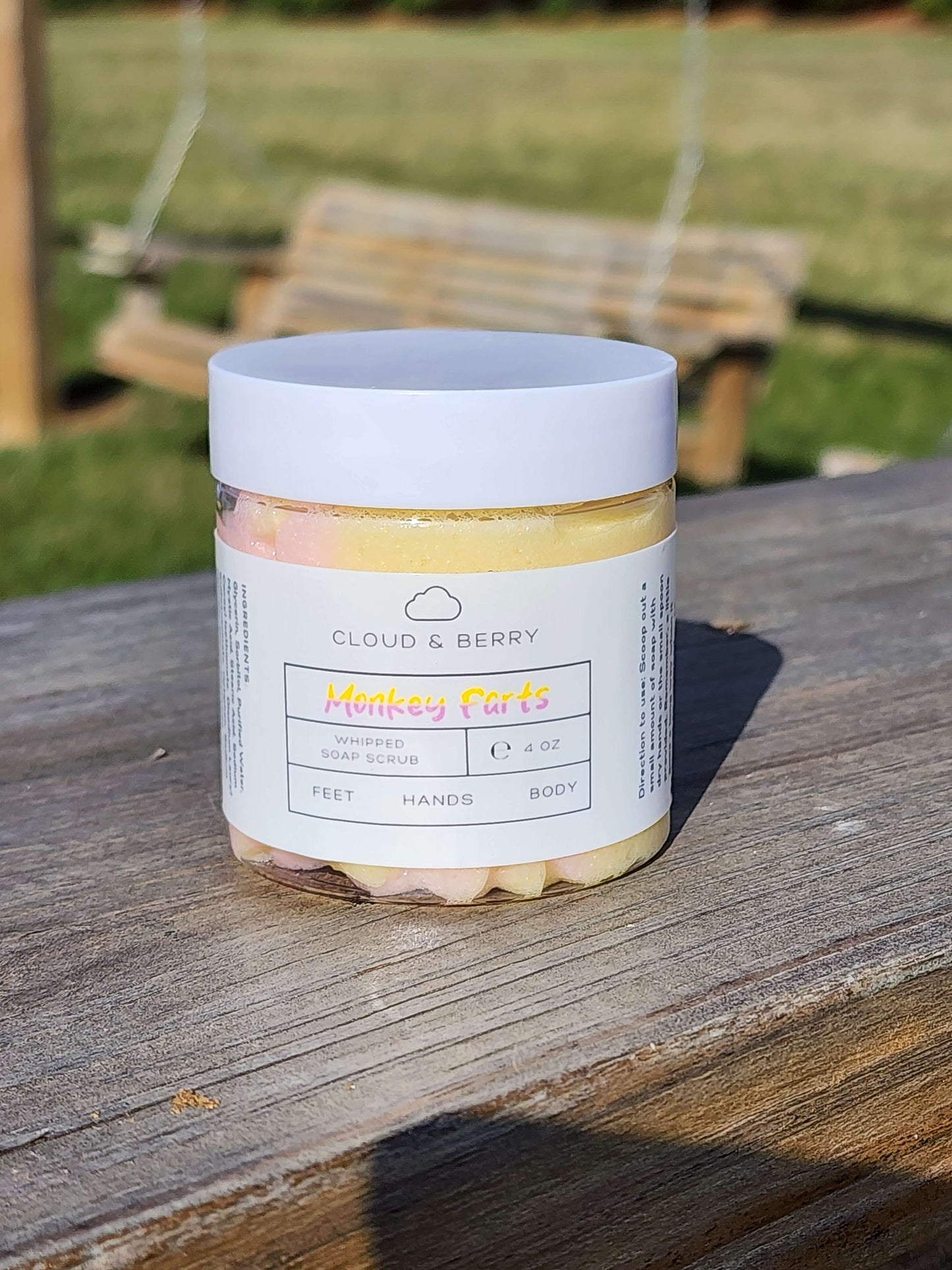 Monkey Farts whipped sugar scrub with pink-yellow swirls.